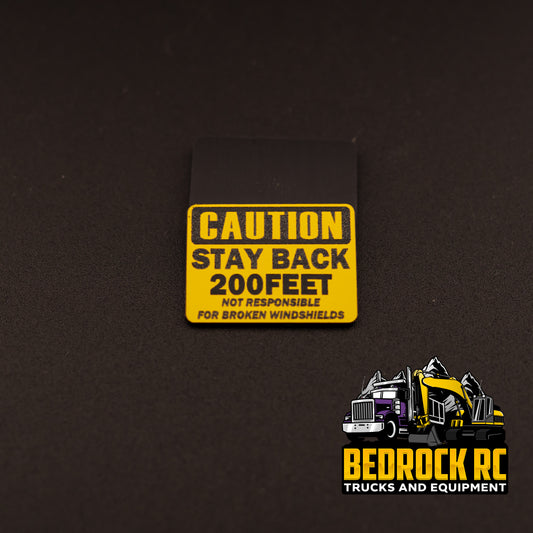 Bedrock Built Caution – Stay Back 200 Feet – Not Responsible for Broken Windshields sign for 1/14 scale RC trucks, laser-etched hard plastic, 31.5mm x 23mm, made in-house by Bedrock RC